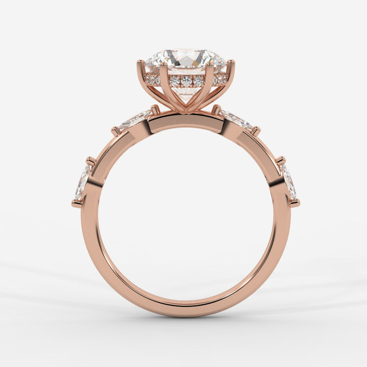 A profile view of a rose gold ring highlighting the prong-set round lab-grown diamond with marquise-cut lab-grown side diamonds and a hidden halo.