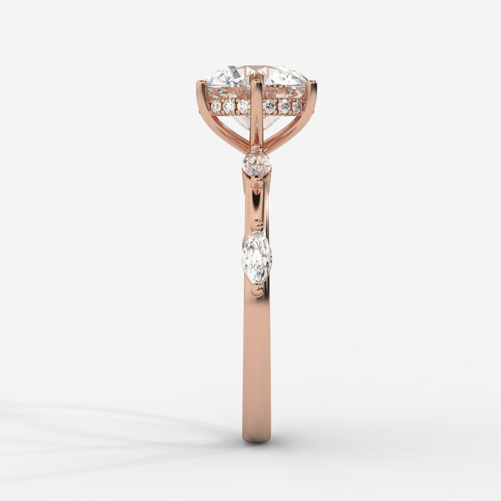 A front view of a rose gold engagement ring displaying a round lab-grown diamond in a hidden halo setting with marquise-cut lab-grown side diamonds on the band.