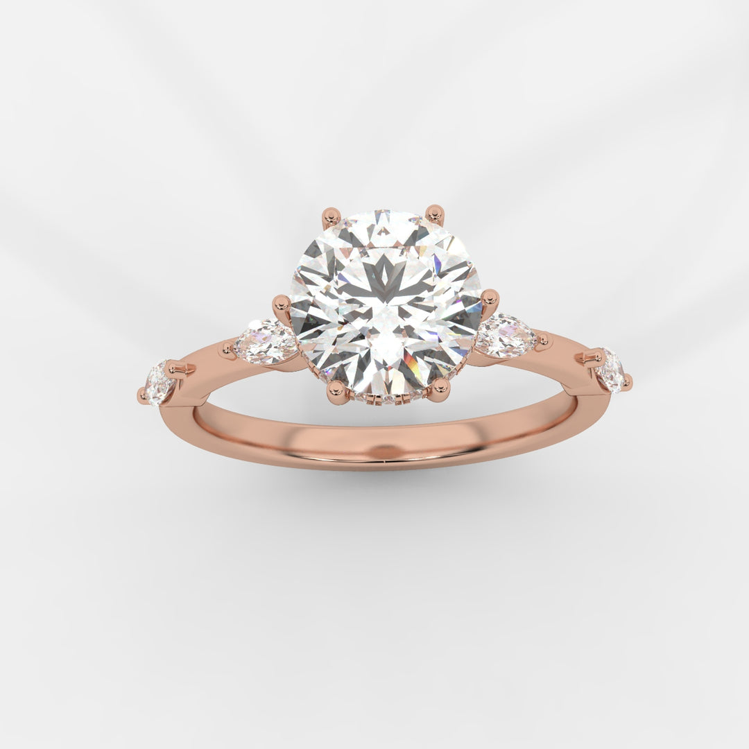 A top view of a rose gold engagement ring featuring a round-cut lab-grown diamond in a hidden halo setting, with marquise-cut lab-grown side diamonds along the band.