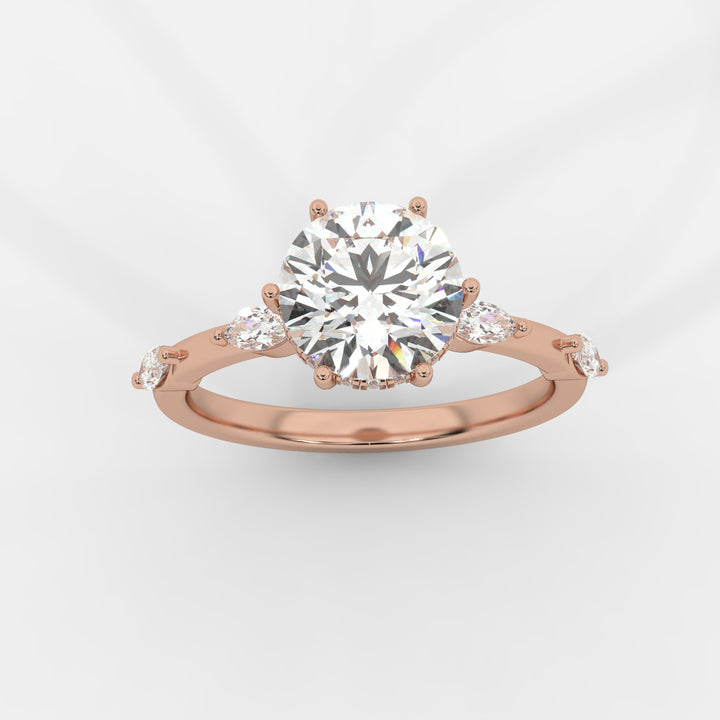 A top view of a rose gold engagement ring featuring a round-cut lab-grown diamond in a hidden halo setting, with marquise-cut lab-grown side diamonds along the band.